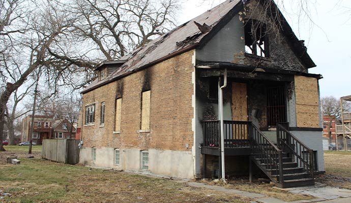 A fire damaged boarded-up house