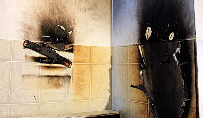 A wall corner showing fire damage