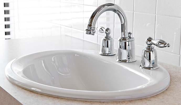 Bathroom porcelain vanity sink with chrome faucet fixture