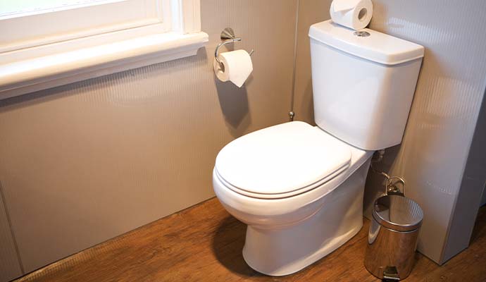 Clean toilet installed on a wood floor