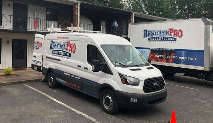 RestorePro service vehicles at fire damaged building