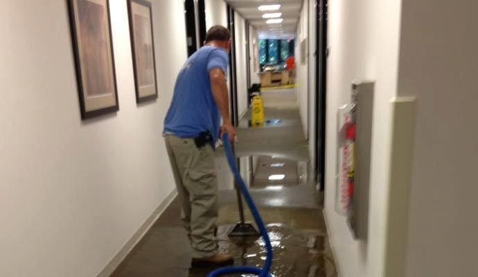 Cleaning hallway water damaged floor with equipment