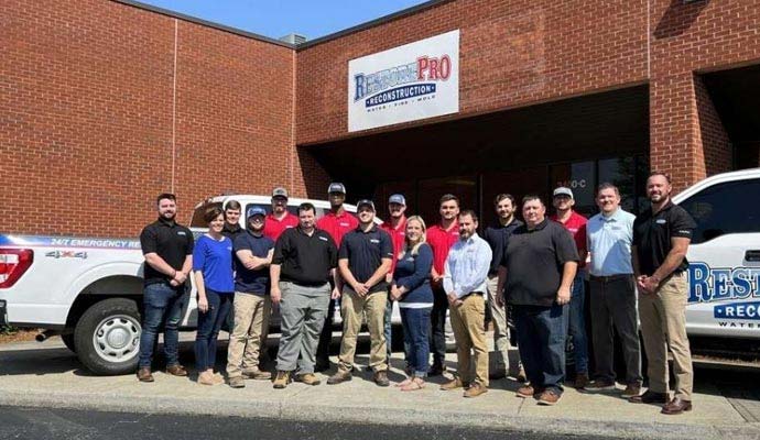 RestorePro Reconstruction team and technicians standing outside the company facility