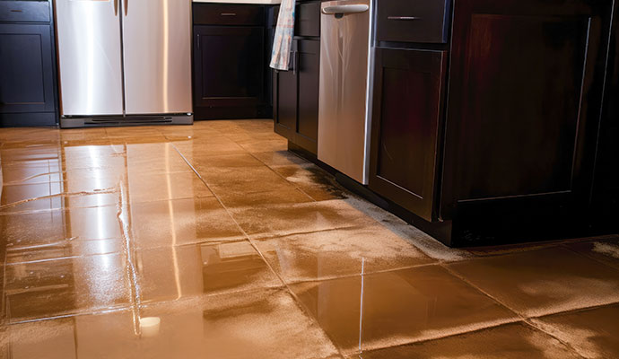 Water damaged tiled kitchen floor due to plumbing leak